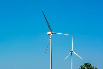 Wind turbines with power line in the sunset 