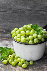 Fresh ripe green gooseberry on wooden background