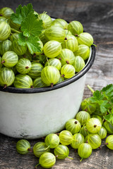 Fresh ripe green gooseberry on wooden background