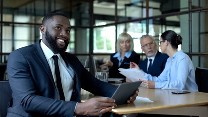 Happy businessman holding tablet, satisfied with successful business project