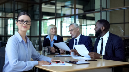 Successful female boss smiling camera, business colleagues working office table