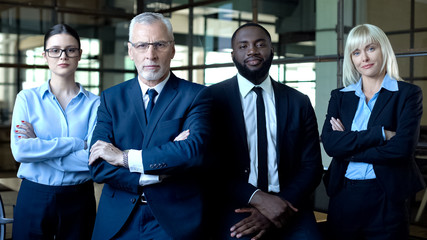 Professional lawyers folded arms looking camera, business career, strategy