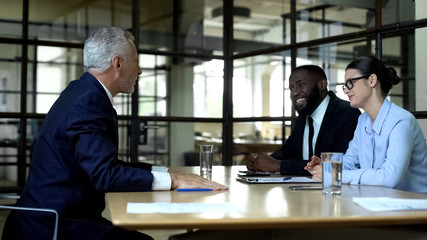 Friendly business partners having meeting in office, project negotiation