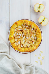 Apple galette with cinnamon and almonds on a wooden table. Homemade pie.
