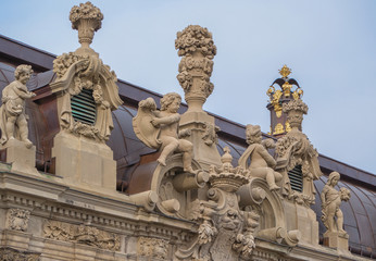 Fototapeta na wymiar Zwinger, a palace in German city of Dresden, built in Baroque style. Sculptures on the roof. Architecture sightseeing in Germany. World historical heritage