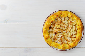 Apple galette with cinnamon and almonds on a wooden table. Homemade pie.
