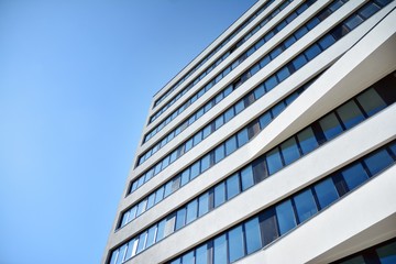 Facade fragment of a modern office building. Exterior of glass wall with abstract texture.