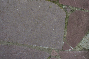 Background of stone-paved uneven track. Construction. Pieces of stone. Handwork.