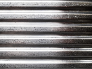 Scratched silver ridged corrugated metal panel