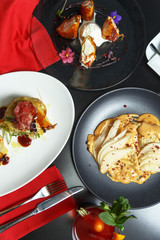 Pancakes, a traditional dish of Russian national cuisine on a black table. Restaurant serving. Top view.