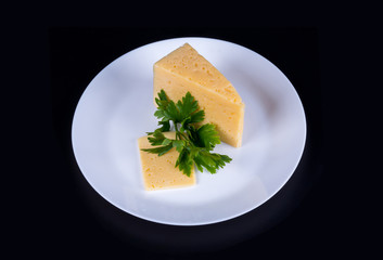 piece of cheese on a white plate
