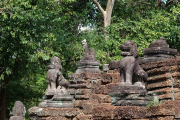 The stair of the ruined medieval university in Cambodia. Stone figures of animals. Ancient ruins.
