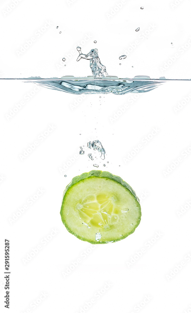 Wall mural Fresh sliced cucumber in water isolated on white background. One slice