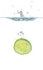 Fototapeta na wymiar Fresh sliced cucumber in water isolated on white background. One slice