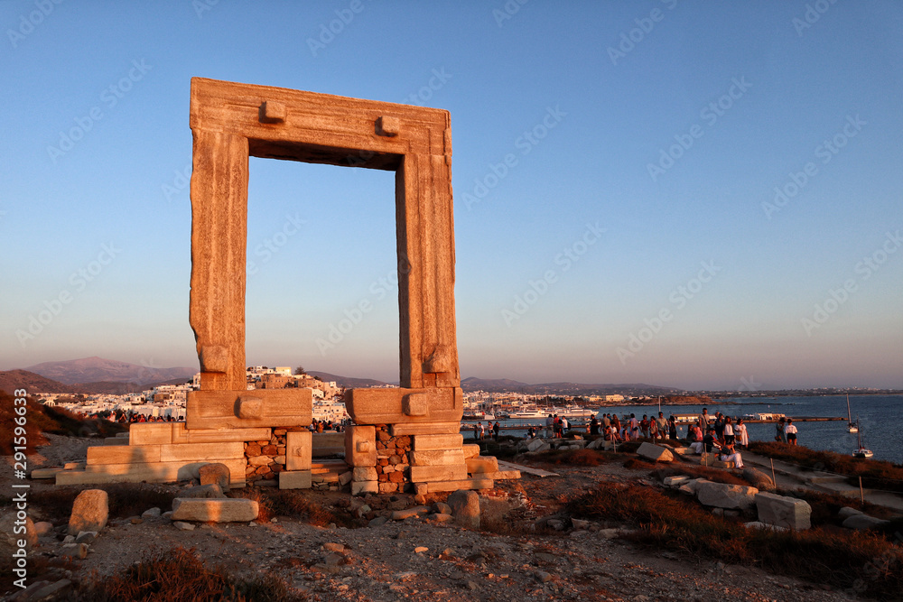 Wall mural sunset at naxos portara, apollo's 6th cent bc temple ruins, overlooking naxos town, greek islands