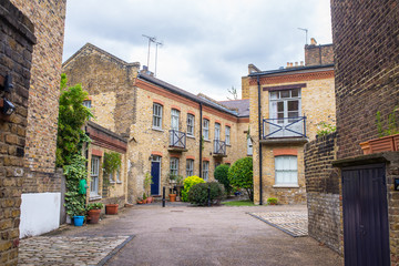 Fototapeta na wymiar Exclusive mews with red brick residential houses in London