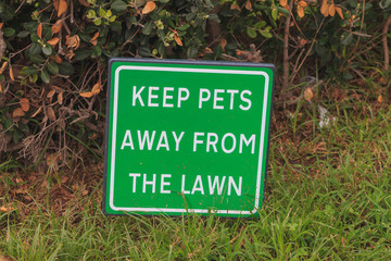 Green infrmation sign KEEP PETS AWAY FROM THE LAWN