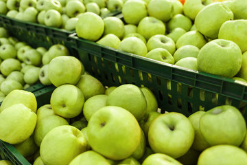 Baskets of apples on the store counter. Fruit on display in the supermarket