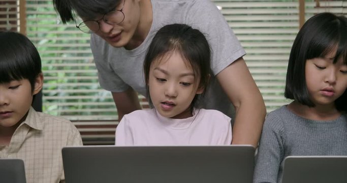 Teacher Works with Young Boy and Girl in a Computer Science Class. Educatio and Technology Concept.
