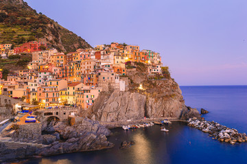 Fototapeta na wymiar Stunning view of the beautiful and cozy village of Manarola in the Cinque Terre Reserve at sunset.
