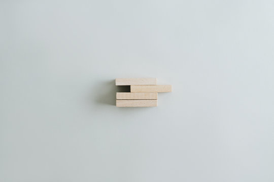 Four wooden pegs in a stack