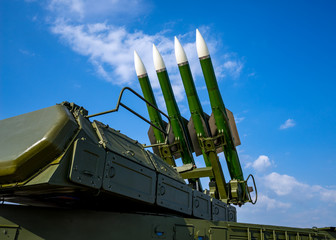 Ballistic missile launcher with four cruise missiles on powerful mobile transportation on background blue sky, antiaircraft forces, military industry - 291602676