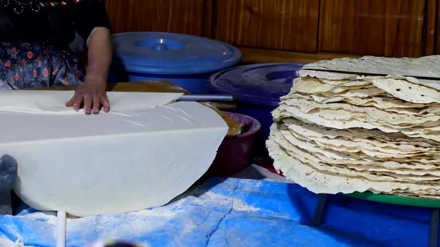 women making yufka bread in tandoor,