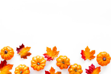 Autumn background with leaves and pumpkins on white top view space for text frame