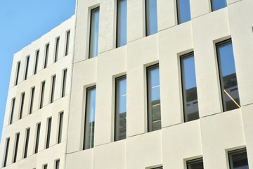 Modern office building detail. Perspective view of geometric angular concrete windows on the facade of a modernist brutalist style building. 