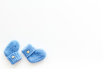 Cute baby booties for boy on white background top view copyspace
