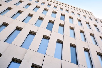 Modern office building detail. Perspective view of geometric angular concrete windows on the facade...