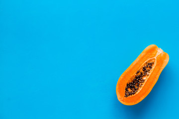 Exotic fruit. Papaya on blue background top view copy space