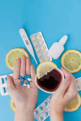 Medications, pills, thermometer, traditional medicine for treating colds, flu, heat on a blue background. Maintenance of immunity. Seasonal diseases. Top view. Medicine flat lay