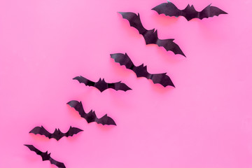 Halloween design. Bats on pink background top view copy space