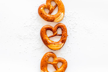 Octoberfest symbol. Fresh bavarian pretzels on white background top view copy space