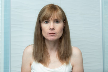 Middle aged woman staring straight ahead