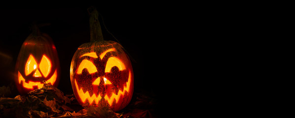 luminous pumpkins in the dark for the autumn Halloween holiday. Jack's grinning head. Magical bright neon green and red light in the darkness of Freezelight. All Saints' Day...