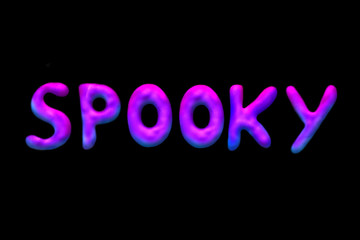 Textured  lettering neon "Spooky" inscription  isolated at black background. Halloween logo in cartoon style.