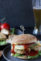 Brain Burger. Fried brains beef, calf or sheep are fried in deep fried as a cutlet in a burger. shows a sandwich in a section. fashionable exotic food. Zombie food. weird food. hipster food