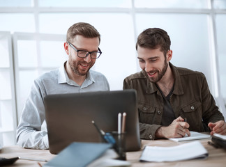 close up. colleagues discussing online information in the workplace