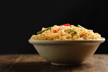 Instant noodles in a bowl, placed on a wooden,copy space