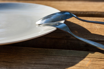 Empty plate with spoon and fork