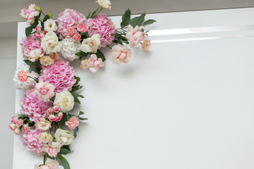 Wedding decorations. Holiday decoration vase with fresh flowers near the wedding arch. Pink roses and carnations