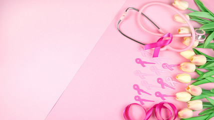 Obraz na płótnie Canvas Pink Ribbon Breast Cancer Awareness Month concept flat lay on pink background with copy space.