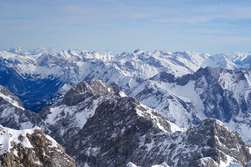 Fototapeta na wymiar Alpine mountains, panoramic view from the top of the Zugspitze peak, Germany. It lies south of the town of Garmisch-Partenkirchen. 