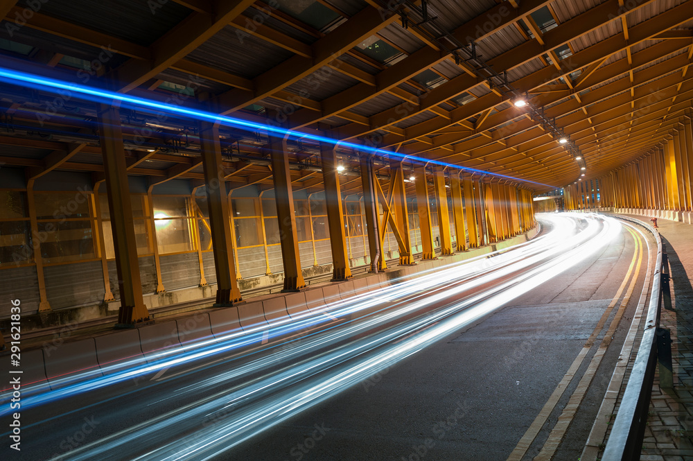 Poster light trails and head lights of traffic in tunnel. transportation background