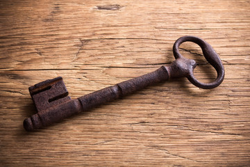Old key on a wooden background