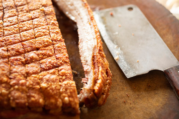 crispy pork with chinese knife placed on wooden chopping block