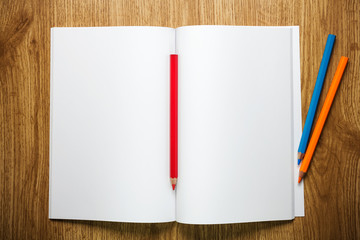 White blank with pencils on a wooden table