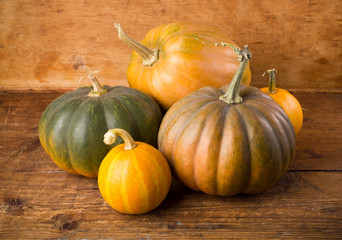Autumn background with pumpkin on wooden board